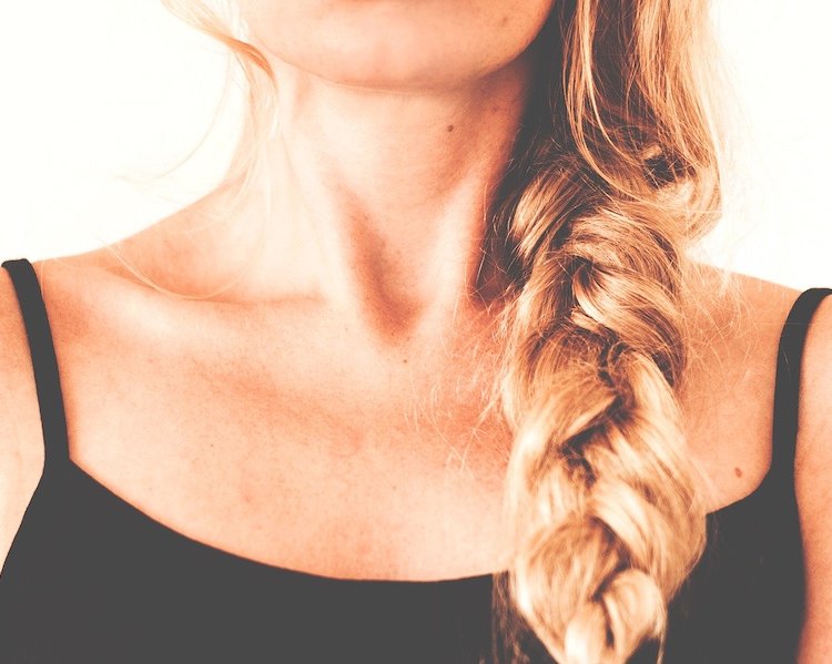 Neck of blonde woman with braided hair
